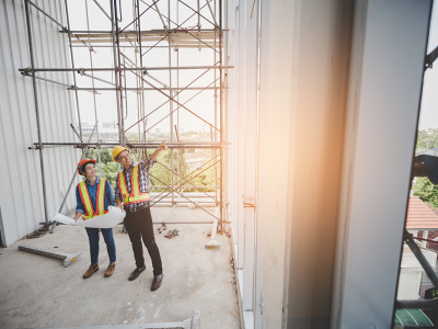 Construction teacher and student on a building site